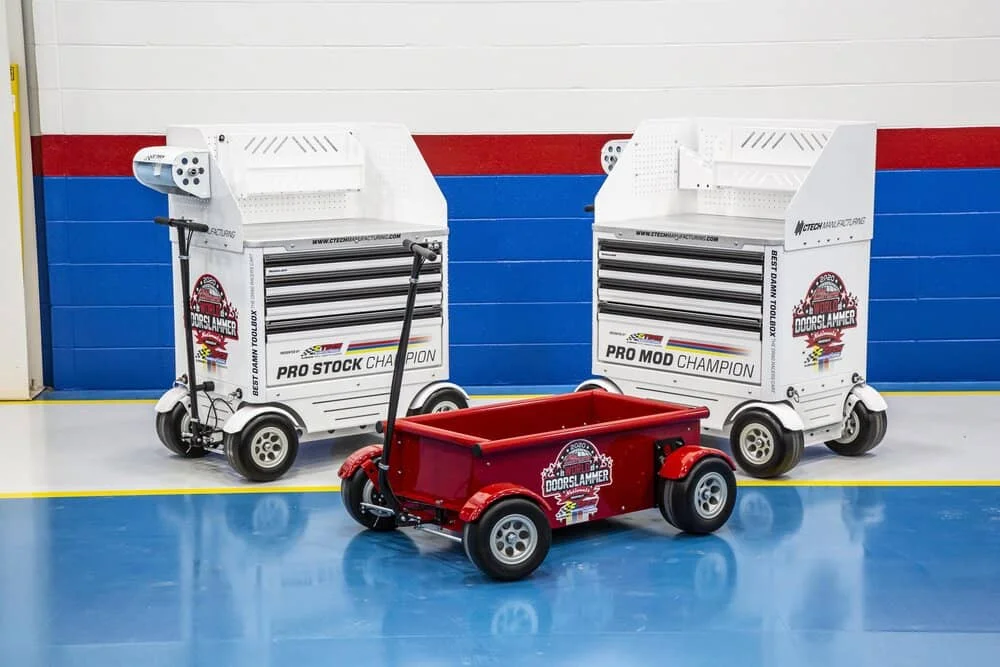 Trophy carts displayed with the “FAN GIVEAWAY” Hot Rod Wagon