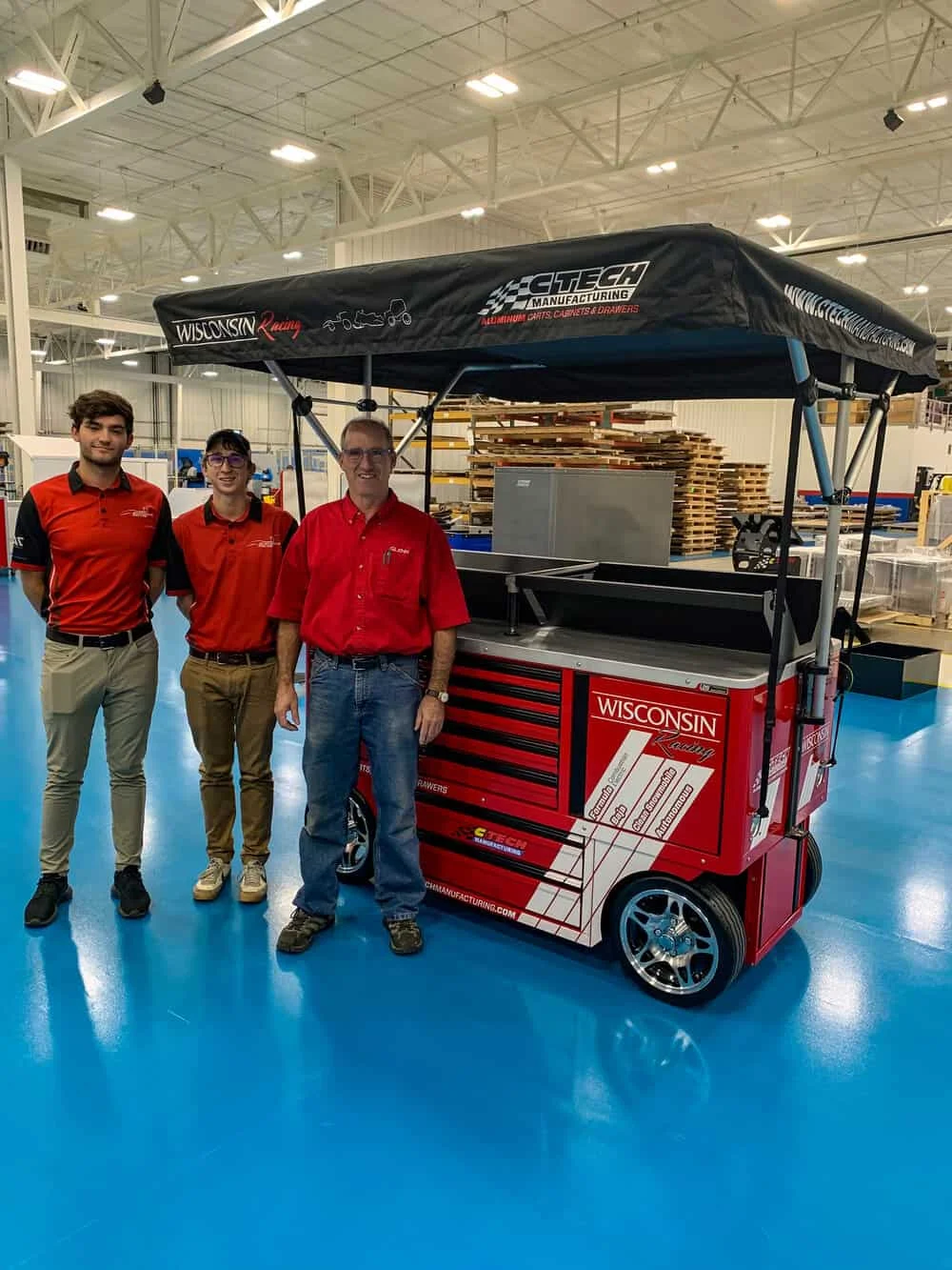Pictured here is UW-Madison SAE program advisor ; Dr. Glenn Boyer, and team members at the CTech Manufacturing headquarters receiving their new Track Support Cart.