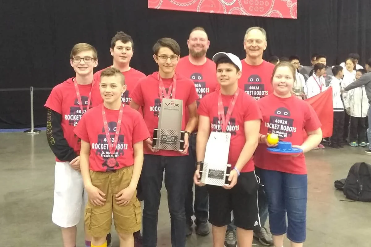 Students Competing In VEX Robotics World Championships Pose With Their Trophy